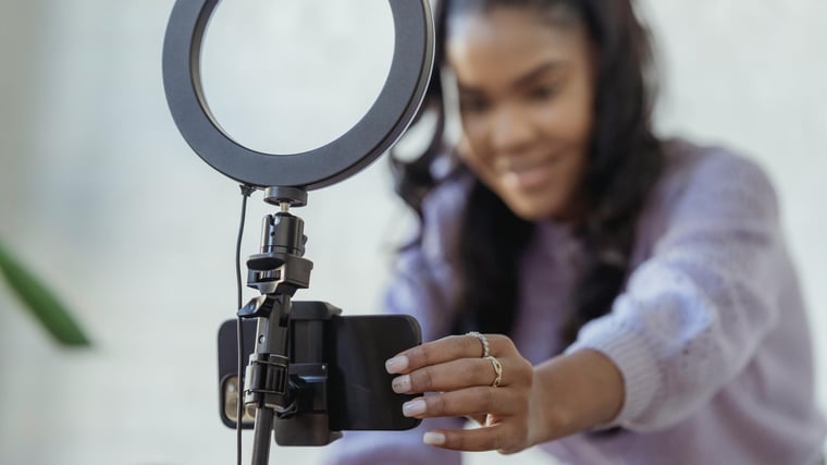 Photo by George Milton: https://www.pexels.com/photo/happy-young-black-woman-setting-up-smartphone-before-shooting-podcast-6954220/